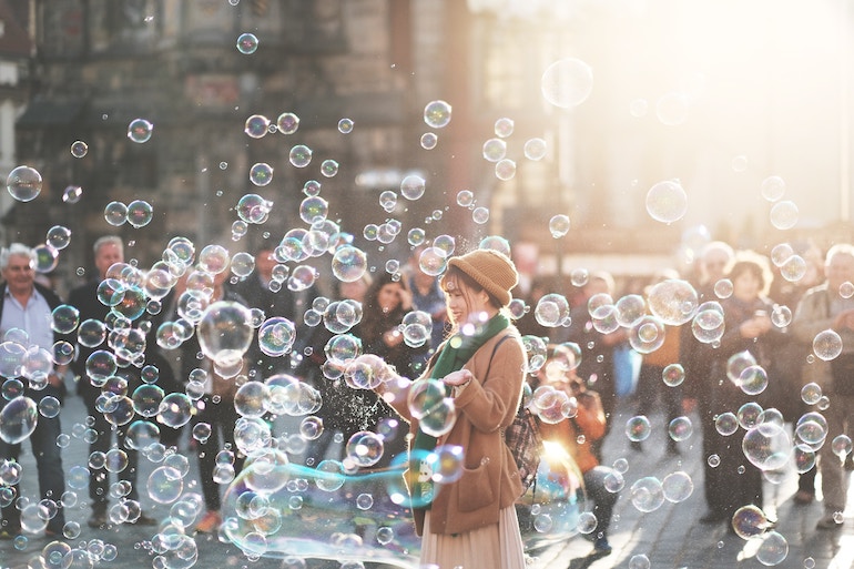 Frau macht Seifenblasen - glücklich sein