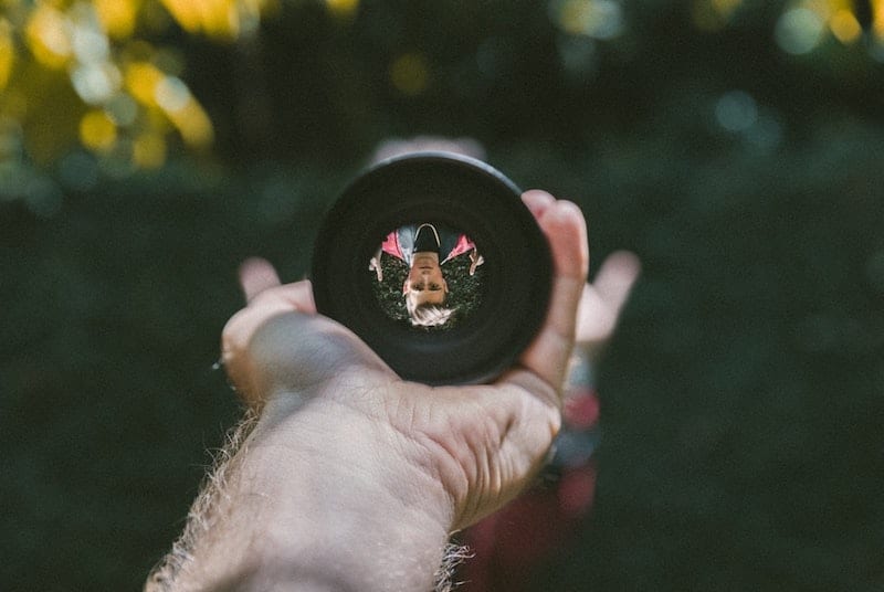 Man upside down in a lens reflection